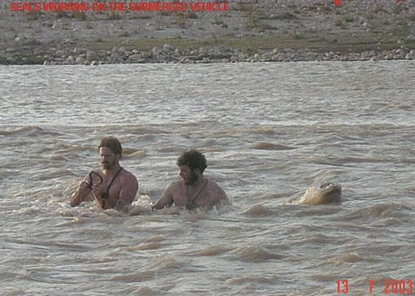 SEALs working on the submerged vehicle